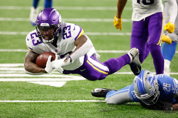 Minnesota Vikings running back Mike Boone (23) dives forecextra yard in the second half against the Detroit Lions during an NFL football game, Saturda