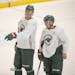 Wild forwards Nick Bjugstad, left, and Zach Parise were on the ice for the team’s first day of practice at Tria Rink in St. Paul on Monday.