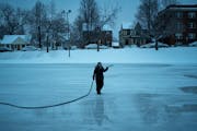 Top, park keeper Leslee Hagberg sprayed another layer of water on a Minneapolis skating rink. Above, Ali Hassan helped keep his 4-year-old daughter, S