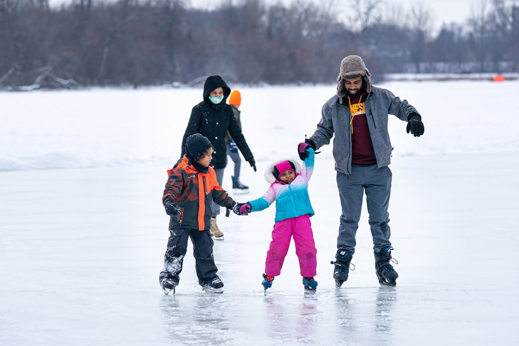 In December 2020, Ali Hassan held the hand of his daughter, Sophia Kadir, as they skated on Lake of the Isles in Minneapolis with her brother Sabir Kadir.