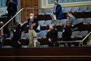 Lawmakers prepare to evacuate the House gallery as protesters try to break into the House Chamber at the U.S. Capitol on Wednesday, Jan. 6, 2021, in W
