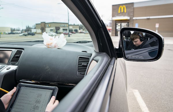 Colton Rebarich worked on choir homework in his mom’s car in a McDonalds parking lot in Virginia, MN on Monday. They have to sit in the parking lot 