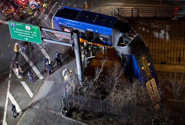 Bus dangles from overpass in NYC