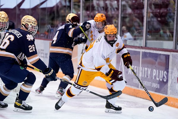 Mason Nevers (18) took control of the puck for the Gophers against Notre Dame defenseman Zach Plucinski (26) when the teams met last January.