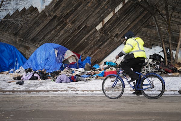 Crews cleaned up a homeless encampment on Shepherd Road in St. Paul, Minn. where fire left one person dead and one person injured. ]  Shari L. Gross �
