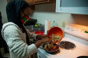 University of Minnesota student Zubeda Chaffe cooks cacabsa with other members of the Oromo Student Union. Cacabsa, a traditional Sudanese dish made o