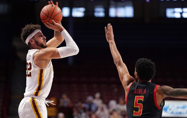 Minnesota guard Gabe Kalscheur took an outside shot as Maryland guard Eric Ayala reached to block in the first half.