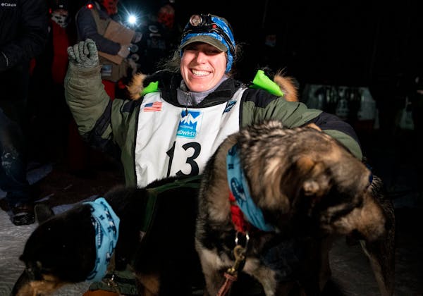 Erin Letzring celebrated with her lead dogs after she won the John Beargrease sled dog marathon by what organizers said was the smallest margins in hi