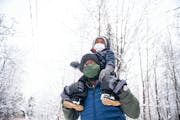 Glenn Simmons Jr. carries his son, Kai, 2, atop his shoulders as they walk through the Bagley Nature Center in Duluth, Minnesota on Sunday, Nov. 15, 2
