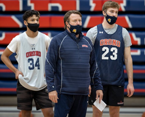 Orono basketball coach Barry Wohler with players Isaiah Hagen and Connor Chappell.