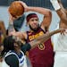 Cleveland Cavaliers’ JaVale McGee, center, drives to the basket against Minnesota Timberwolves’ Naz Reid, left, and Jaden McDaniels , right.