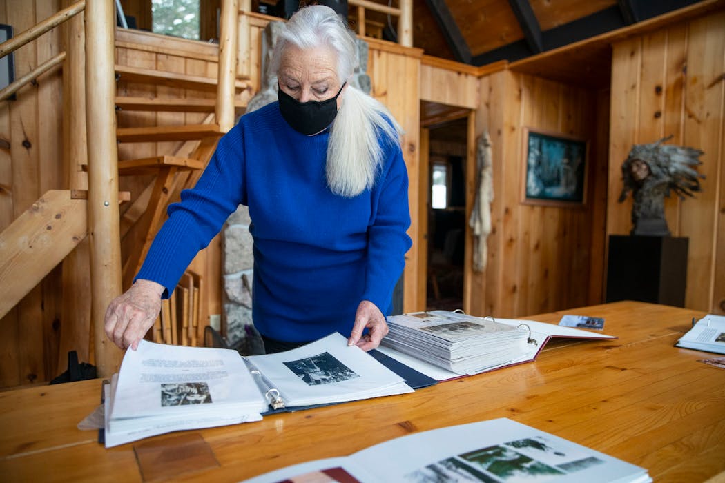 At her cabin, Leddy looked through photos books stuffed with images of their deep Gunflint Trail history.