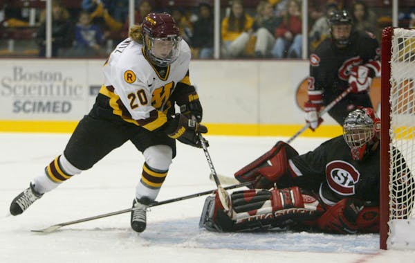 Minneapolis, MN. October 19, 2002. Gopher women’s hockey vs. St. Cloud. Gophers #20 Natalie Darwitz  shoots and scores her first goal of the game ag