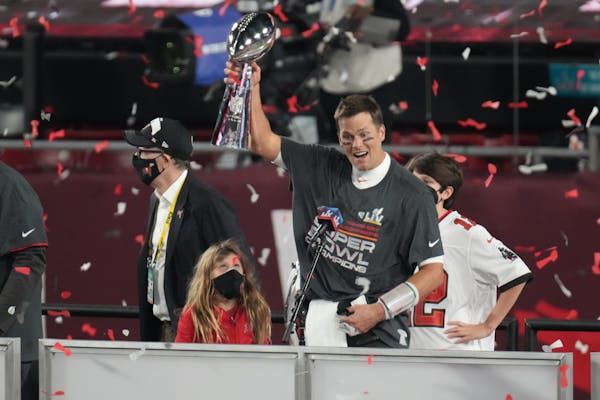 Tampa Bay Buccaneers quarterback Tom Brady holds the Vince Lombardi Trophy after winning Super Bowl LV 