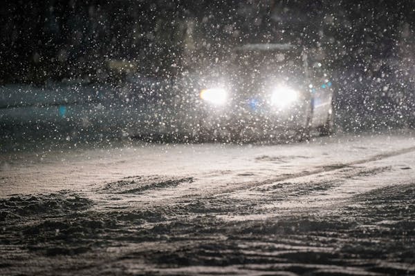 Cars move slowly through falling snow on Plano Road near Renner Road as a second winter storm hit Texas on Tuesday night. The power crisis that hit so