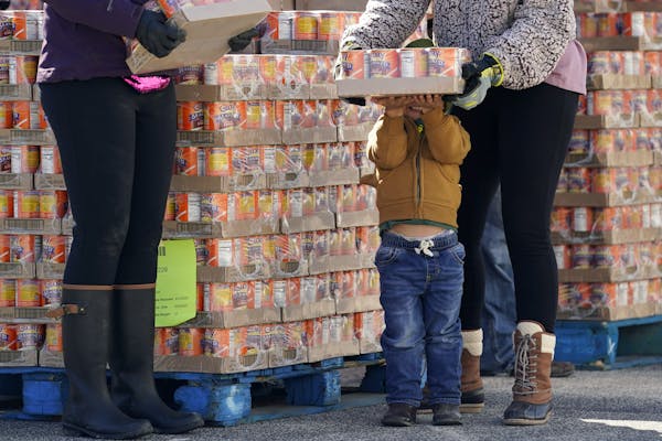 Kash Meggison, 3, helped pass out canned food Friday at a San Antonio Food Bank drive-through food distribution site held at Rackspace Technology in S