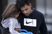 Bryce Williams, 26, of Staples held his daughter Kinley Rose, 3, on their way to his basketball league game late last month.
