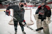 Centennial girls’ hockey assistant coach Maddie Rooney talked to goalie Anna Peterson during practice at Centennial Sports Arena. ] LEILA NAVIDI •