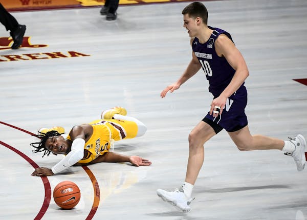 Northwestern forward Miller Kopp chased down the ball as Gophers guard Marcus Carr lost control and fell to the court in the second half. 
