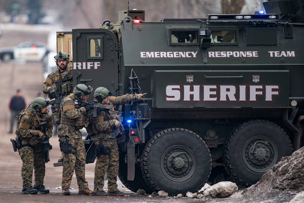 St. Louis County sheriffs were armed with rifles and grenade launchers as they maintained a perimeter and attempted to force the gunman out of his hou