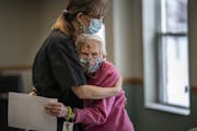 Wally Emery, left, who serves meals at Oak Meadows Senior Home in Oakdale, gave resident Donna Chapp a welcome hug.