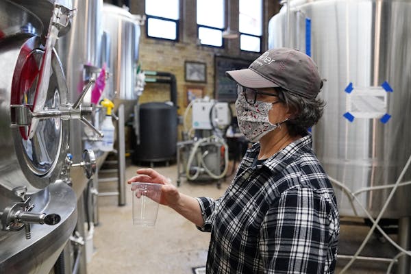 Deb Loch, master brewer and co-owner of Urban Growler Brewing Co., took a sample from one of the tanks Wednesday afternoon. 