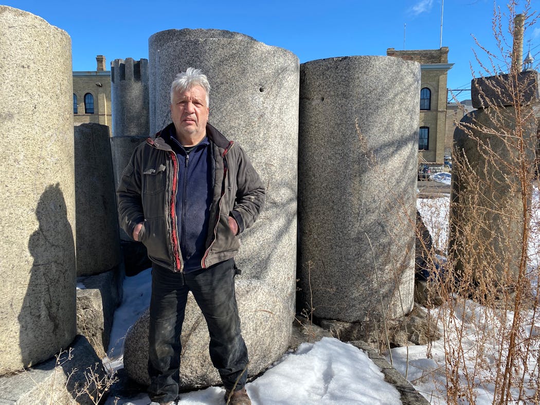 Zoran Mojsilov stands in front of the Great Northern Depot columns at his outdoor studio and sculpture garden in Northeast Minneapolis.