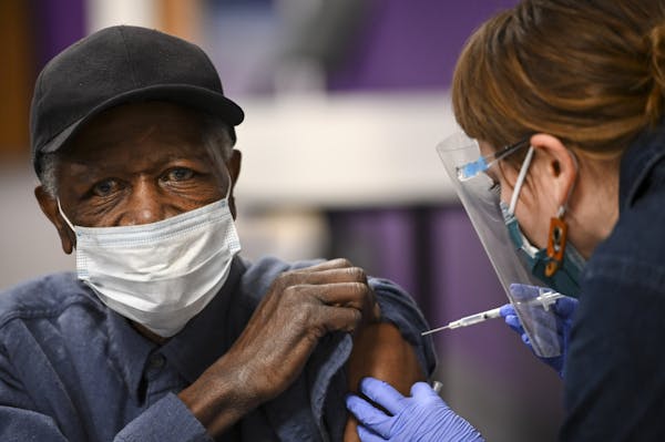 M Health Fairview nurse Nicole Parr administered a dose of the Pfizer BioNTech COVID-19 vaccine Feb. 19 to James Wells, 73, of Minneapolis at Shiloh T
