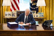 President Joe Biden signs the American Rescue Plan in the Oval Office in Washington on Thursday. Even before the plan’s passage, this year’s defic
