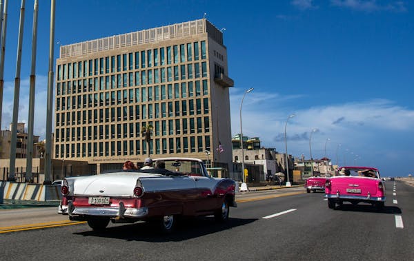 In this Oct. 3, 2017, photo, tourists rode classic convertible cars on the Malecon beside the U.S. Embassy in Havana.