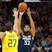 Timberwolves center Karl-Anthony Towns (32) shoots as Utah Jazz center Rudy Gobert (27) defends in a game from Nov. 18, 2019. (AP Photo/Rick Bowmer)