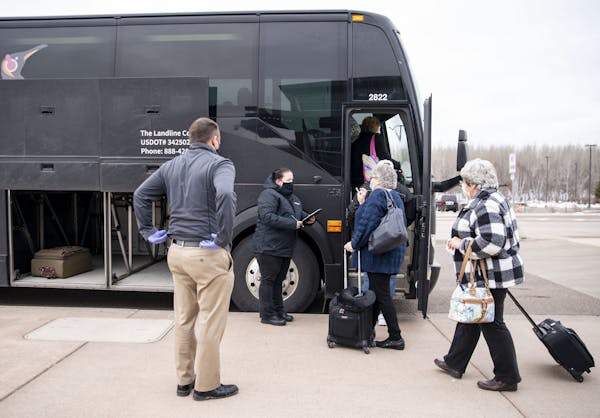 Theresa Thornton, a motor-coach operator for Landline, checked passengers in as they boarded at Duluth International Airport. ]