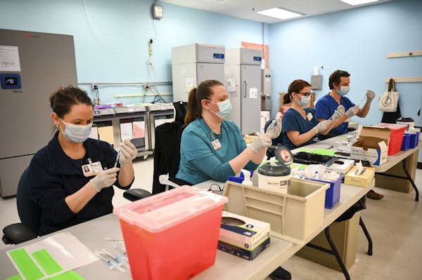 From left, Blue Cross and Blue Shield of Minnesota nurses Alison Stumne, Tamara Pierre, Jana Wagner and Kirk Randall filled syringes at a North Memori