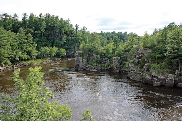 The St. Croix River cuts through a basalt gorge known as the Dalles of the St. Croix in St. Croix Falls. The dramatic rock walls are part of Interstat