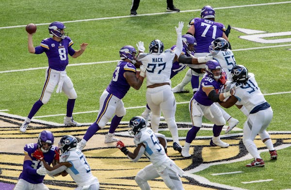 Vikings offensive line and quarterback Kirk Cousins during a September game against the Titans.