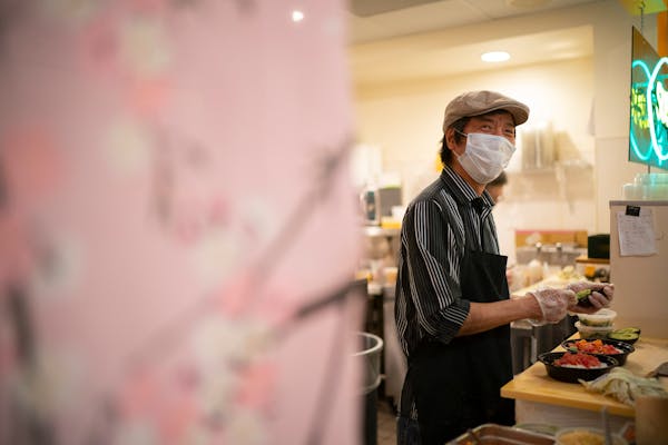 Jun Abematsu smiled at a regular customer from behind the counter at his Sushi Takatsu in the Baker Center.