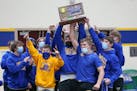 Kimball Area wrestlers celebrate their Class 1A wrestling championship. The Cubs defeated Bertha-Hewitt/Verndale/Parkers Prairie in the final dual mat