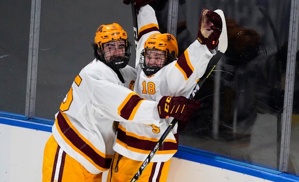 Gophers forward Mason Nevers, right, celebrates his goal with Jack Perbix during the first period against Nebraska Omaha on Saturday night in Loveland