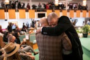 Rep. John Thompson, right, hugged the Rev. Jerry McAfee, pastor of New Salem Baptist Church, during a prayer service for George Floyd’s family Sunda