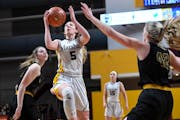 Duluth Marshall guard Gianna Kneepkens (5) scored a basket past New London-Spicer forward Ava Kraemer (42) in the second half.