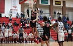 Minnehaha Academy’s Chet Holmgren (34) goes up for a first half dunk against Totino-Grace Friday night. Holmgren had 11 points in the first half as 
