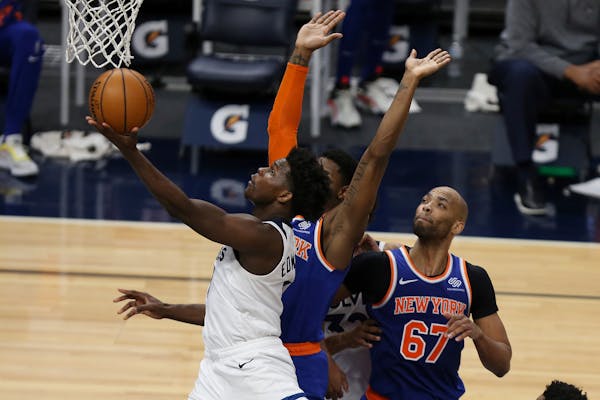 The Timberwolves’ Anthony Edwards goes up to the basket past New York Knicks’ RJ Barrett during the second half 
