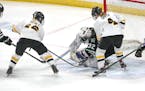 Proctor/Hermantown goaltender Abby Pajari (32) makes a save in the second period under pressure from Warroad’s Abbey Reule 912) and Reanna Smith (4)