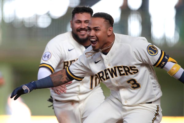 Milwaukee’s Orlando Arcia celebrates with teammates after driving in the winning run during the 10th inning of the team’s Opening Day game against