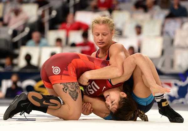 Emily Shilson (top), a three-time national champion at Augsburg, went 1-1 in Saturday’s consolation bracket of the women’s freestyle 50 kg class a