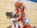 Minneota’s Natalee Rolbiecki went to the basket for two between MIB’s Ava Butler, left, and Hali Savela, during the first half of the game, Tuesda
