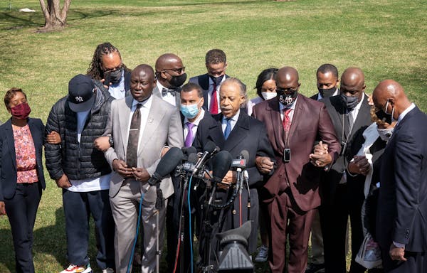 The Rev. Al Sharpton led members and supporters of the Floyd family in prayer outside the Hennepin County courthouse. From left are Terrence Floyd, fo