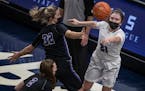 Paige Meyer of Albany right passed the ball around Hannah Graf of Glencoe-Silver Lake at Target CenterTuesday April 6, 2021 in Minneapolis, MN.] Jerry