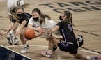Paige Meyer of Albany (center) dove for a loose ball against Brook Christianson left Mylea Monahan (4) of Glencoe-Silver Lake at Target Center Tuesday