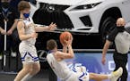 Hayfield’s Easton Fritcher, right, and Isaac Matti, left, hustled for the rebound during the first half of the game, Wednesday, April 7, 2021 at the